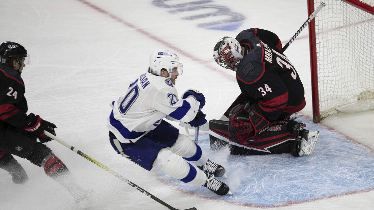 Carolina Hurricanes’ goalie Petr Mrazek (34) stops a shot by Tampa Bay’s Blake Coleman (20) in the third period on Thursday, January 28, 2021 at PNC Arena in Raleigh, N.C.