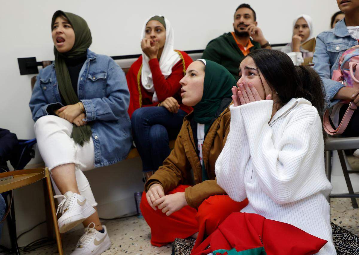 Reem Fayyad, right, reacts while watching the World Cup semifinal match between Morocco and France at La Recette patisserie in Durham, N.C. on Wednesday, Dec. 14, 2022.