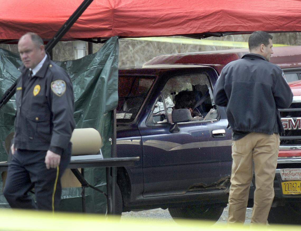 Police work at the scene where a man and a woman were found slain in a pickup truck near the intersection of Routes 55 and 7, Thursday morning, April 12, 2018, in Gaylordsville, Conn. Authorities said the suspect was found dead of a self-inflicted gunshot across the state line in New York.