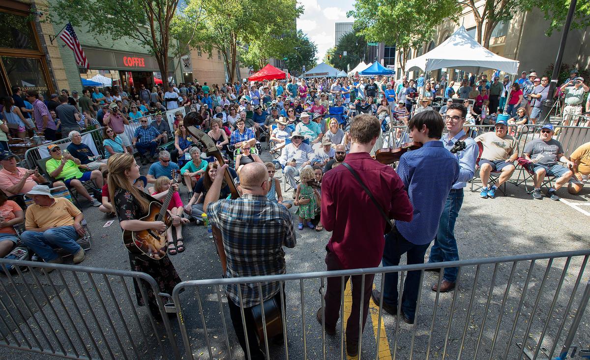With the sound system acting up, The Carolina Pinecones come down into the crowd for their performance at the Hargett Street Stage during Raleigh’s World of Bluegrass on Saturday, Sept. 29, 2018.