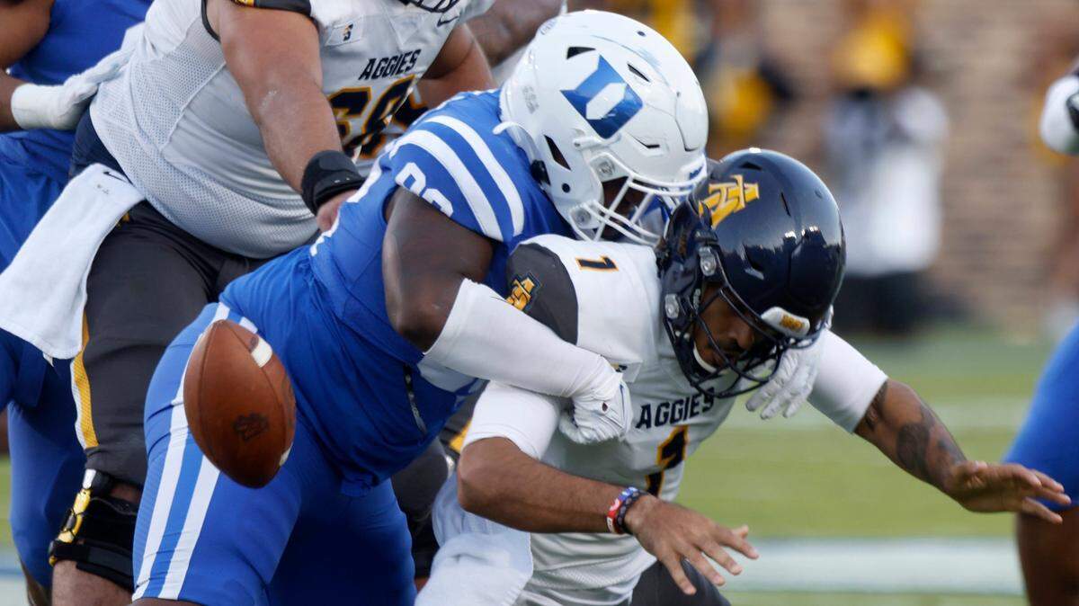 Duke Blue Devils defensive tackle Aeneas Peebles tackles North Carolina A&T Aggies quarterback Jalen Fowler, causing him to fumble the ball, during the first half of Dukes game against North Carolina A&T at Wallace Wade Stadium in Durham, N.C. on Saturday, Sept. 17, 2022.