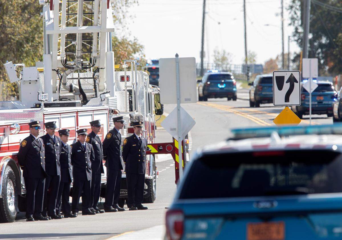 Raleigh Police Department vehicles process on Yonkers Road following the funeral for police officer Gabriel Torres on Saturday, Oct. 22, 2022, in Raleigh, N.C. Torres, 29, was one of five people fatally shot near the Hedingham neighborhood on Oct. 13.