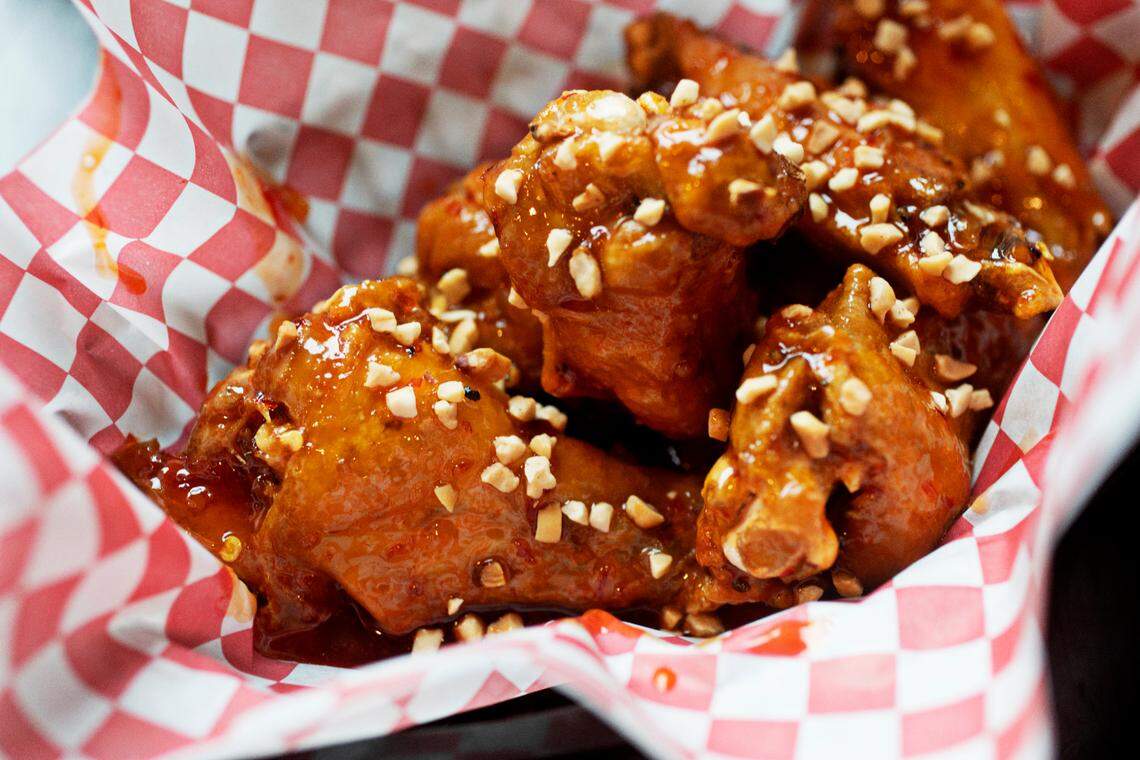 The sweet Thai wings topped with peanuts at Heavenly Buffaloes in Durham on Monday, Feb. 7, 2022.