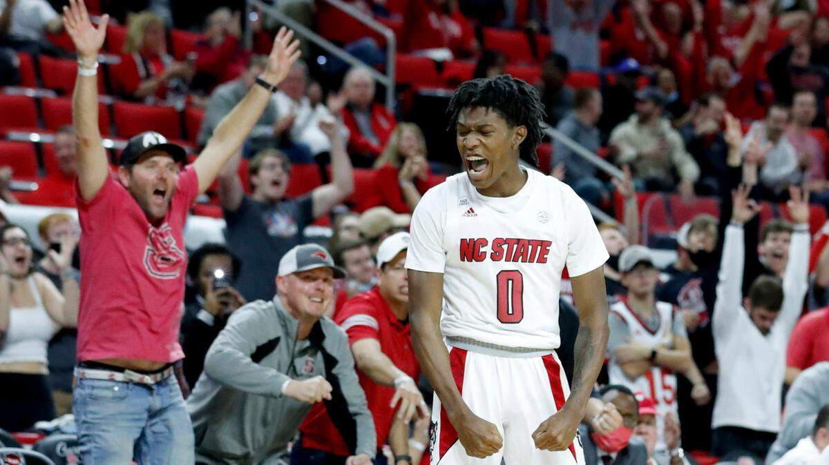 N.C. State’s Terquavion Smith (0) celebrates hitting a three-pointer in the fourth overtime during N.C. State’s 104-100 victory over Nebraska in four overtimes at PNC Arena in Raleigh, N.C., Wednesday, December 1, 2021.