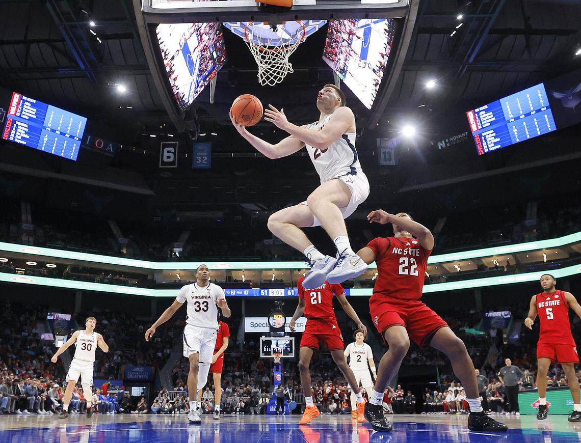 Virginia's Thijs de Ridder drives to the basket past N.C. State's Ven-Allen Lubin during the second half of the Wolfpack’s 81-74 loss in the ACC Tournament quarterfinals on Thursday, March 12, 2026, at the Spectrum Center in Charlotte, N.C. 