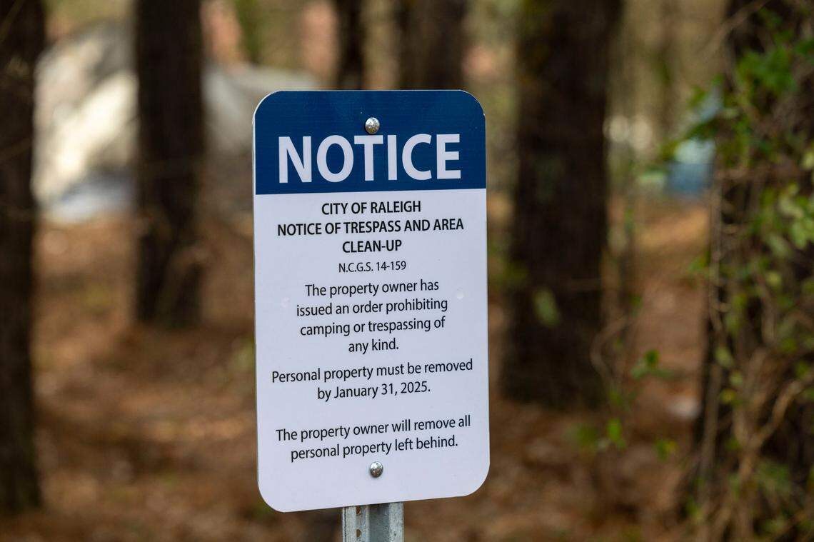 A ’Notice of Trespass’ is posted on a strip of land between Goode Street and The State Farmers Market, notifying those living in an encampment there to vacate the land on Friday, January 31, 2025 in Raleigh, N.C.