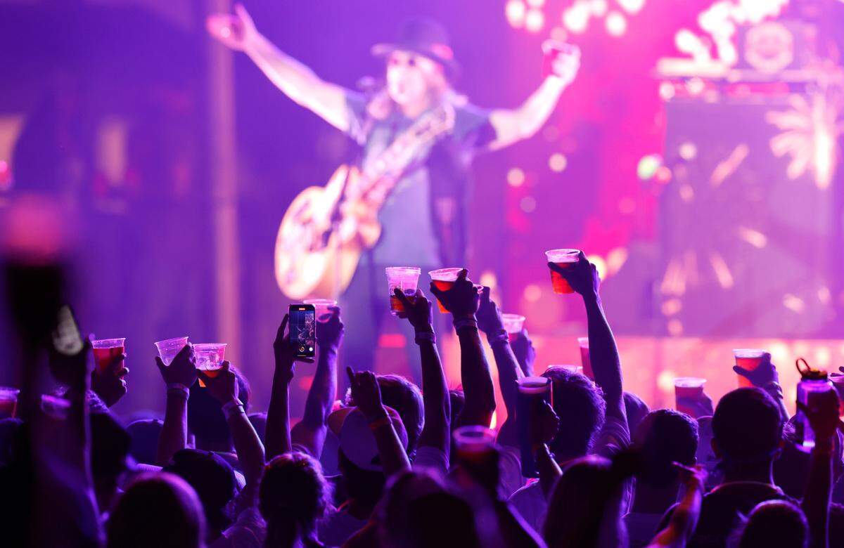 Attendees raise their glasses at “Flagstock 2024,” an invite-only concert event featuring country musicians Big & Rich and Lee Greenwood, among others, at a location in Chapel Hill, N.C., Monday, Sept. 2, 2024. Flagstock started after a GoFundMe raised over $500,000 for a “rager” for UNC-Chapel Hill fraternity brothers who held up the American flag during an April campus protest.