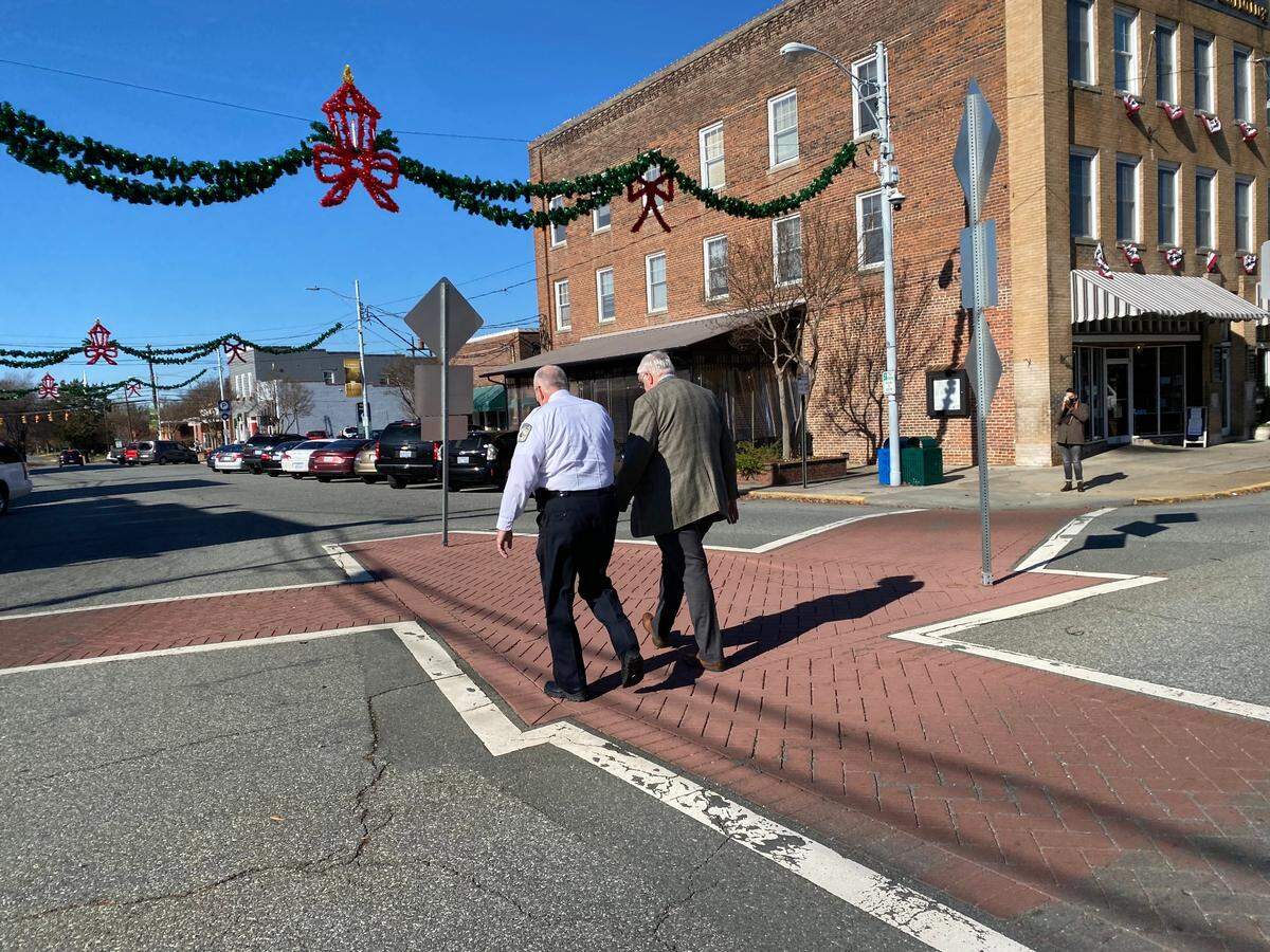 An Alamance County Sheriff’s deputy (left) escorts Tom Boney, publisher of the Alamance News back to his office in Graham, N.C. after he objected to a judgeÕs decision to block reporters from attending a sentencing hearing.