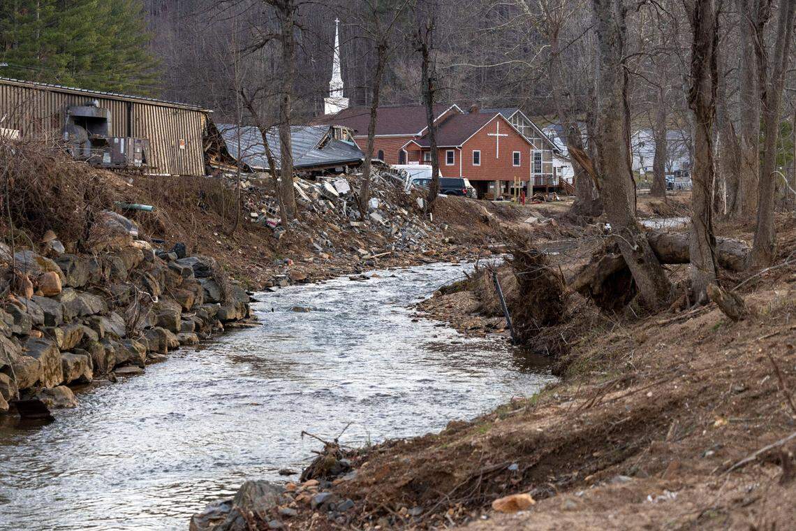 Little Crabtree Creek flows adjacent to the village of Micaville, N.C., on Tuesday, March 11, 2025. The force of several feet of flood water during Hurricane Helene destroyed the former Taylor Toggs manufacturing plant, which had been converted for mixed-use business.