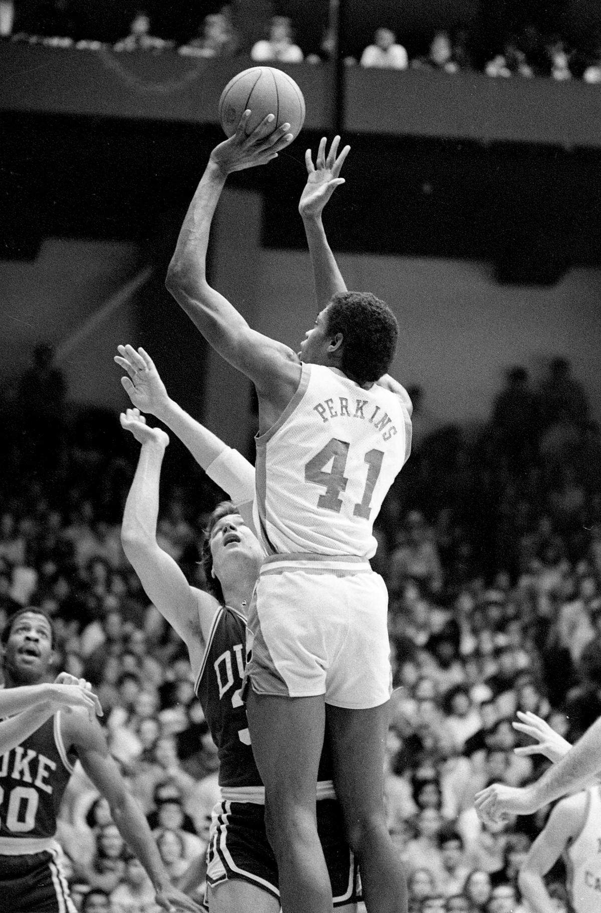 UNC’s Sam Perkins shoots over Duke defenders in the 1981 Duke-Carolina game in Chapel Hill.