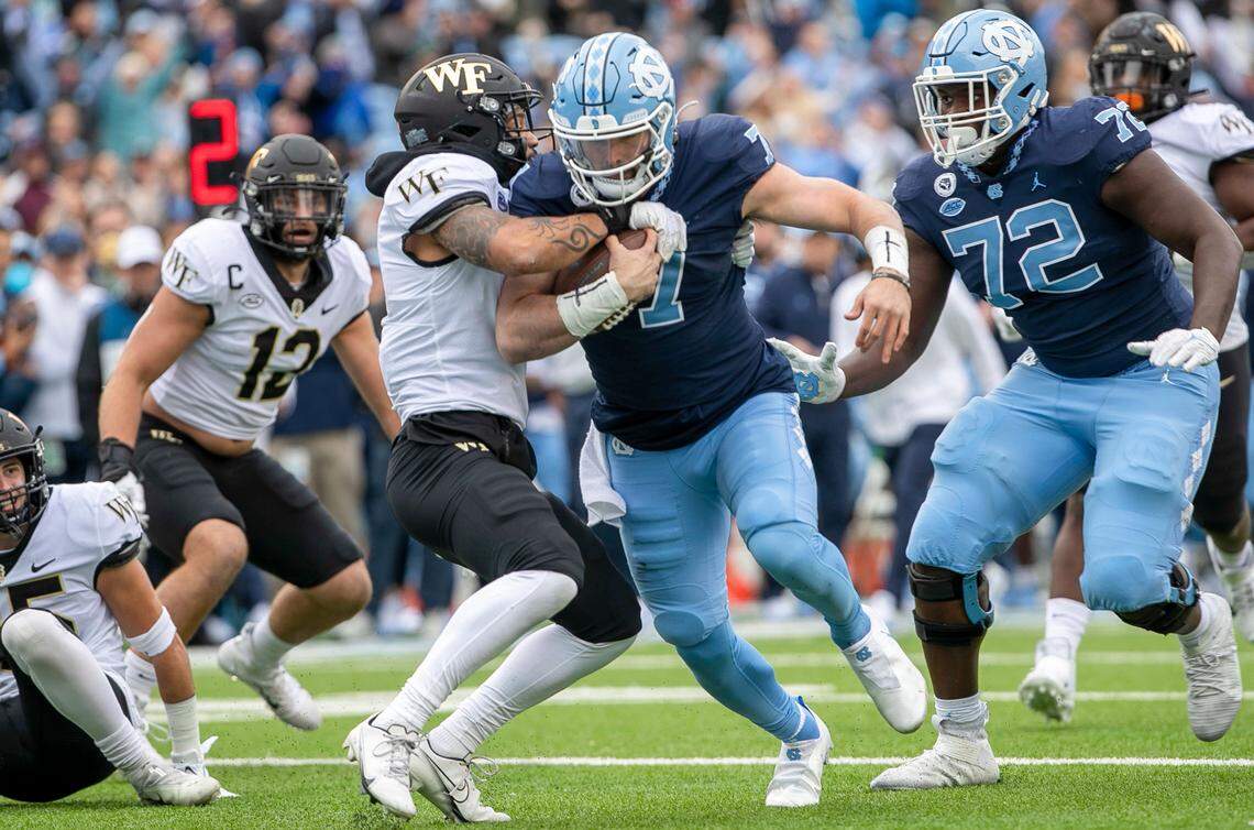 North Carolina quarterback Sam Howell (7) scores a touchdown on an 18-yard run in the first quarter to give the Tar Heels a 7-3 lead over Wake Forest on Saturday, November 6, 2021 at Kenan Stadium in Chapel Hill, N.C.