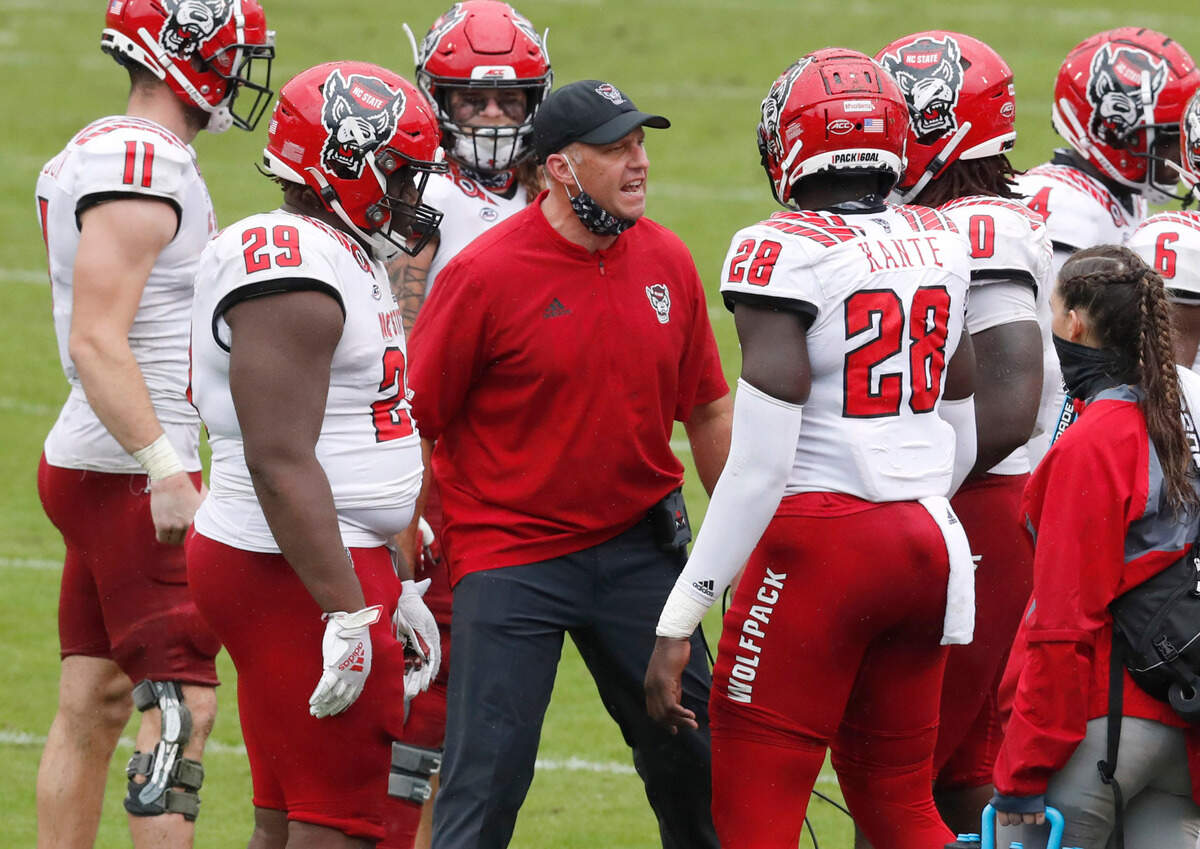 N.C. State head coach Dave Doeren pumps up the defense during the second half of N.C. State’s 38-21 victory over Virginia at Scott Stadium in Charlottesville, Va., Saturday, Oct. 10, 2020.
