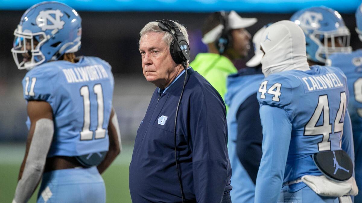 North Carolina coach Mack Brown breaks away from a huddle with the defensive unit late in the fourth quarter as Clemson secured their 39-10 victory in the ACC Championship game on Saturday, December 3, 2022 at Bank of American Stadium in Charlotte, N.C.