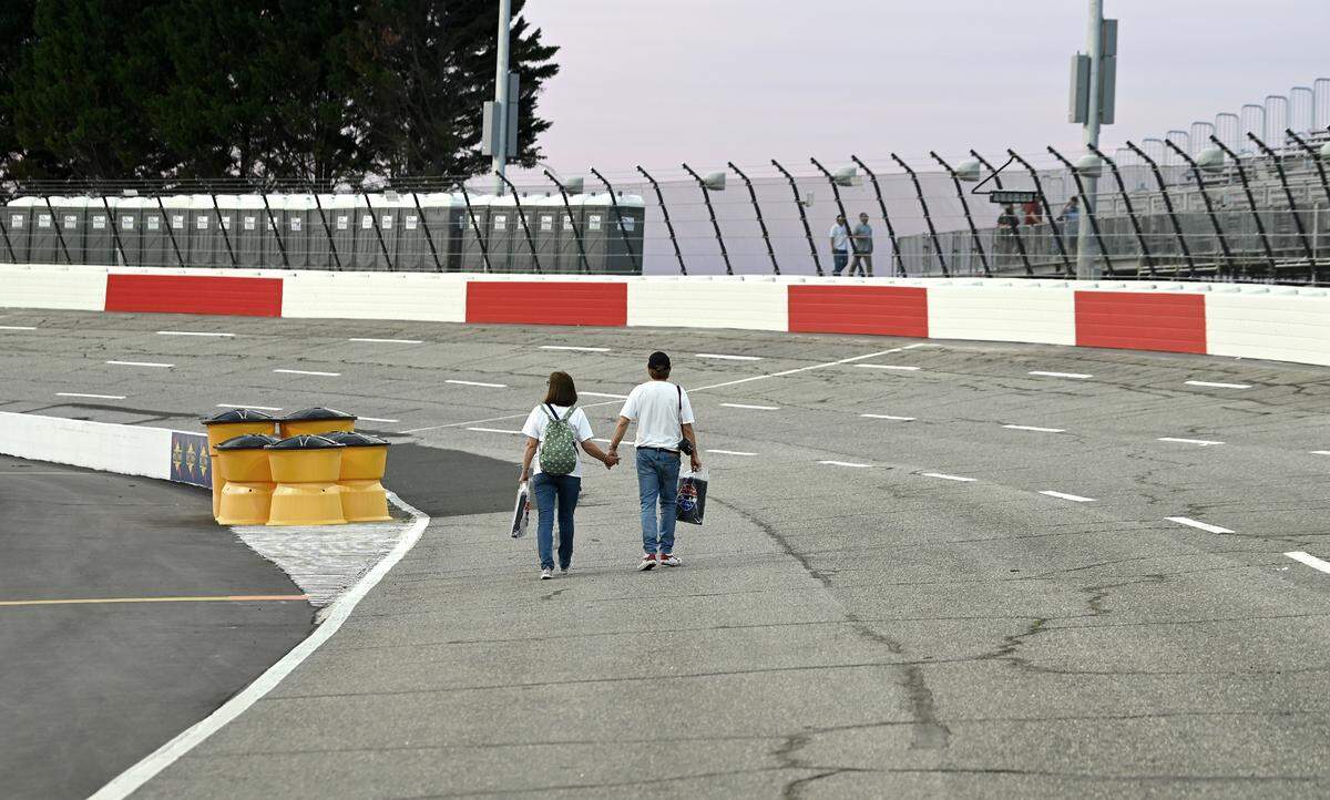 A couple walk North Wilkesboro Speedway hand-in-hand during an open house event at the speedway on Wednesday, May 10, 2023. The speedway will host the NASCAR All-Star race on Sunday, May 21, 2023.