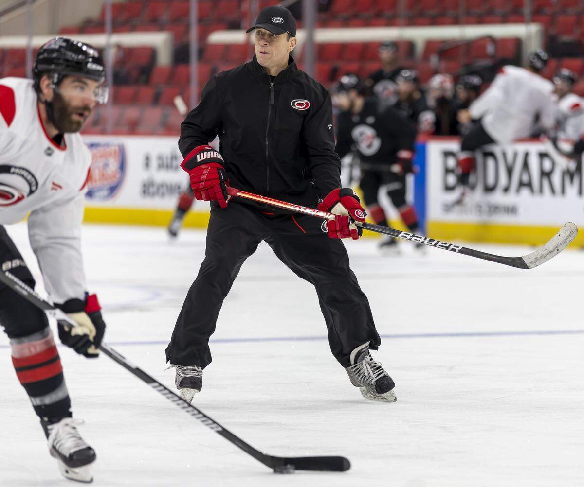 Carolina Hurricanes coach Rod Brind’Amour skates with left wing Jordan Martinook (48) as they prepare for the Game 1 of the Stanley Cup Playoffs against Las Vegas, on Monday June 1, 2026 at Lenovo Center in Raleigh, N.C.