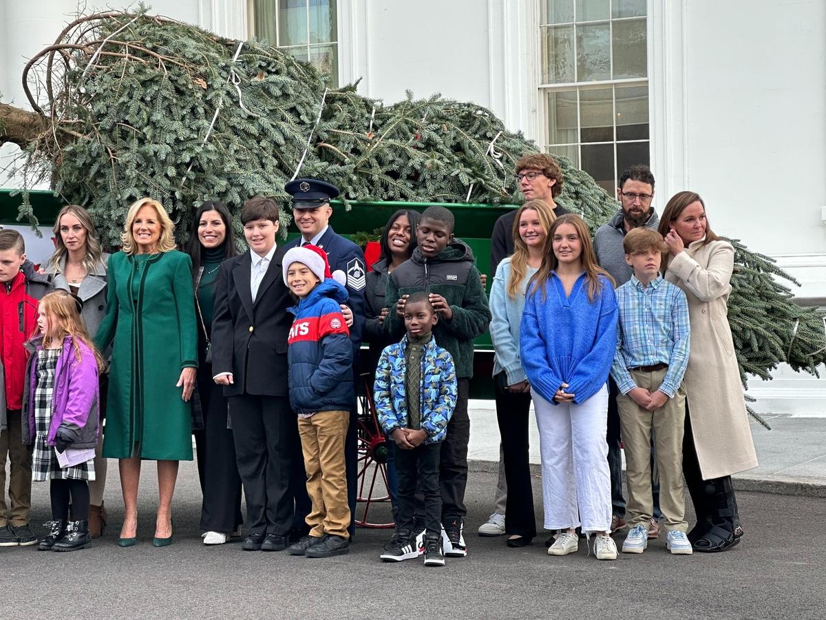 First lady Jill Biden accepts a Frasier Fir tree from Cline Church Nursery as the official White House Christmas tree.