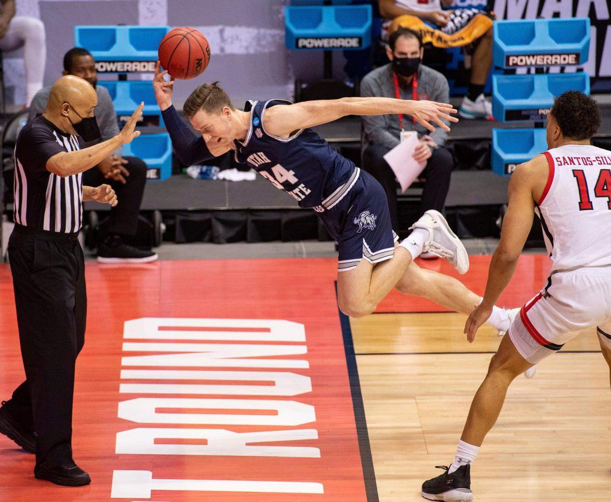 Utah State forward Justin Bean (34) attempts to save the ball from going out-of-bounds during the second half of a first round game against Texas Tech in the NCAA men’s college basketball tournament, Friday, March 19, 2021, at Assembly Hall in Bloomington, Ind. 