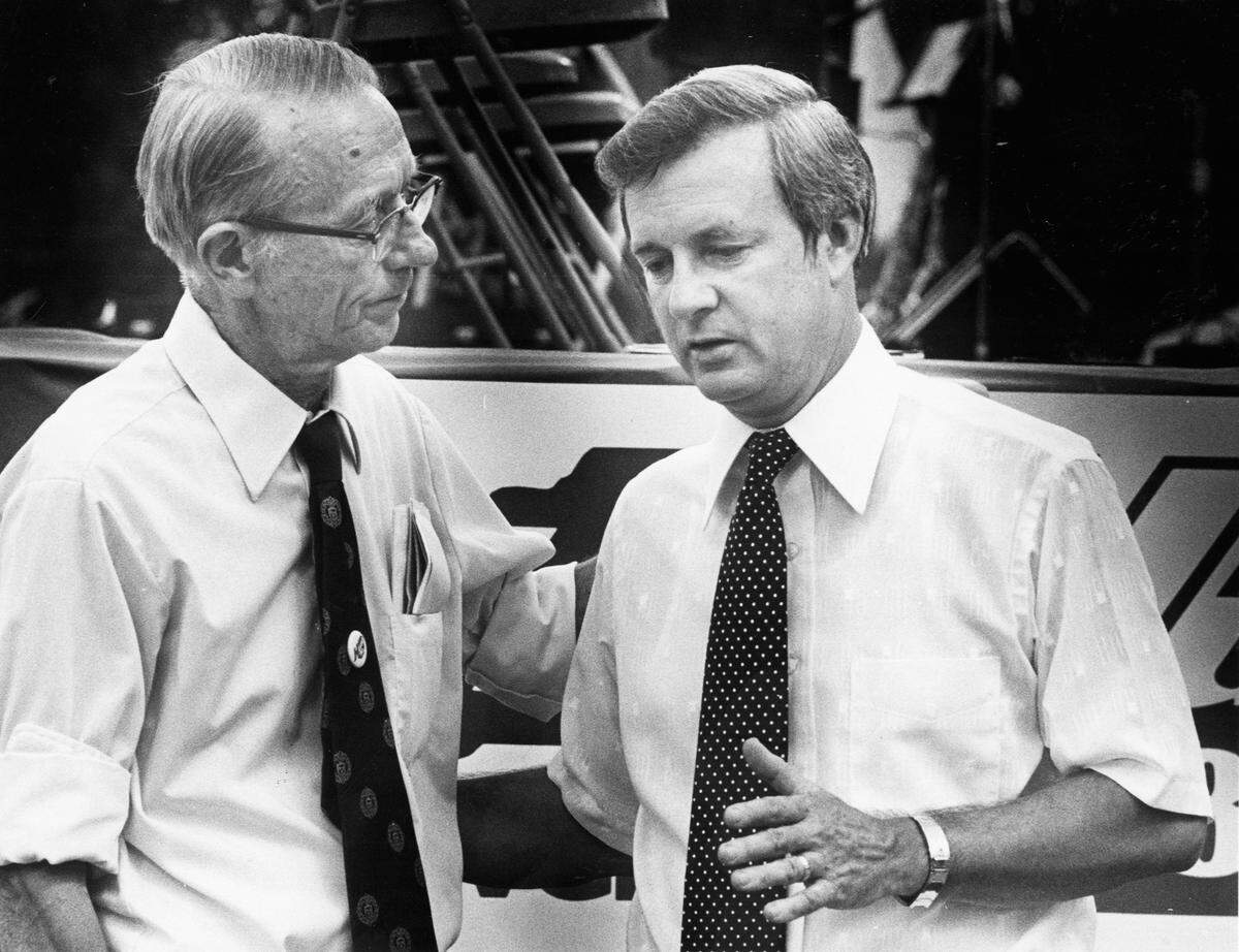 In a 1980 file photo, James Hunt senior and his son Governor James Hunt, Jr. talk over campaign activities at a rally held by the Hunt campaign. 