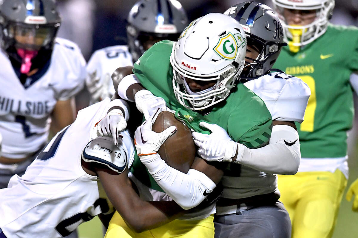 The Hillside defense grapples Cardinal Gibbons’ Braylon Peebles (4) off the kickoff return in the first half. The Cardinal Gibbons Crusaders and the Durham Hillside Hornets met in the third round of the NCHSAA 4A playoffs in Raleigh, N.C. on November 29, 2024.