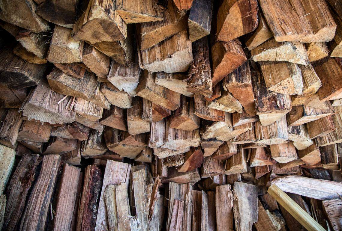 Wood is stacked outside the smoker during the opening of Longleaf Swine in Raleigh Friday, Nov. 4, 2022.