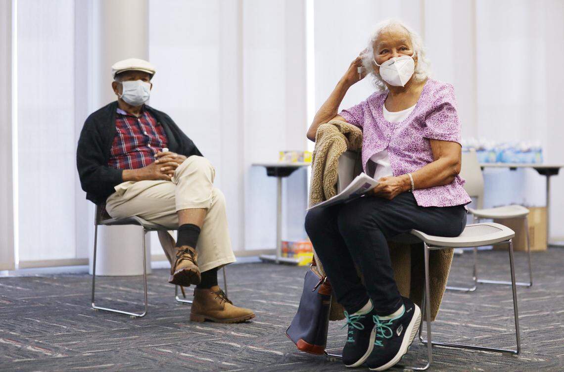 Fledra Hatch, right, and her husband Dr. John W. Hatch, left, wait in an observation area immediately after receiving their COVID-19 vaccines at the Durham County Department of Public Health in Durham, N.C. on Friday, January 8, 2021.