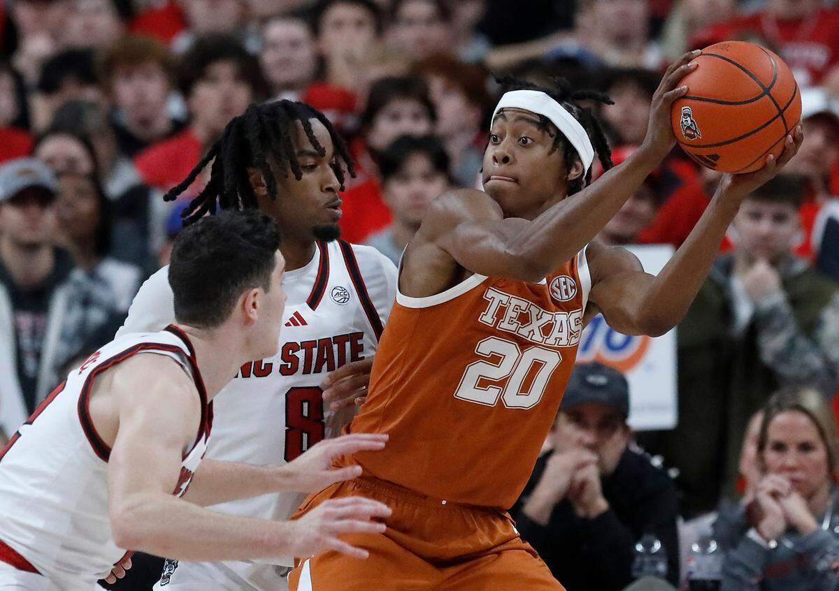 N.C. State’s Michael O’Connell and Jayden Taylor pressure Texas’ Tre Johnson during the second half of the Wolfpack’s 63-59 loss on Wednesday, Dec. 4, 2024, at Lenovo Center in Raleigh, N.C.