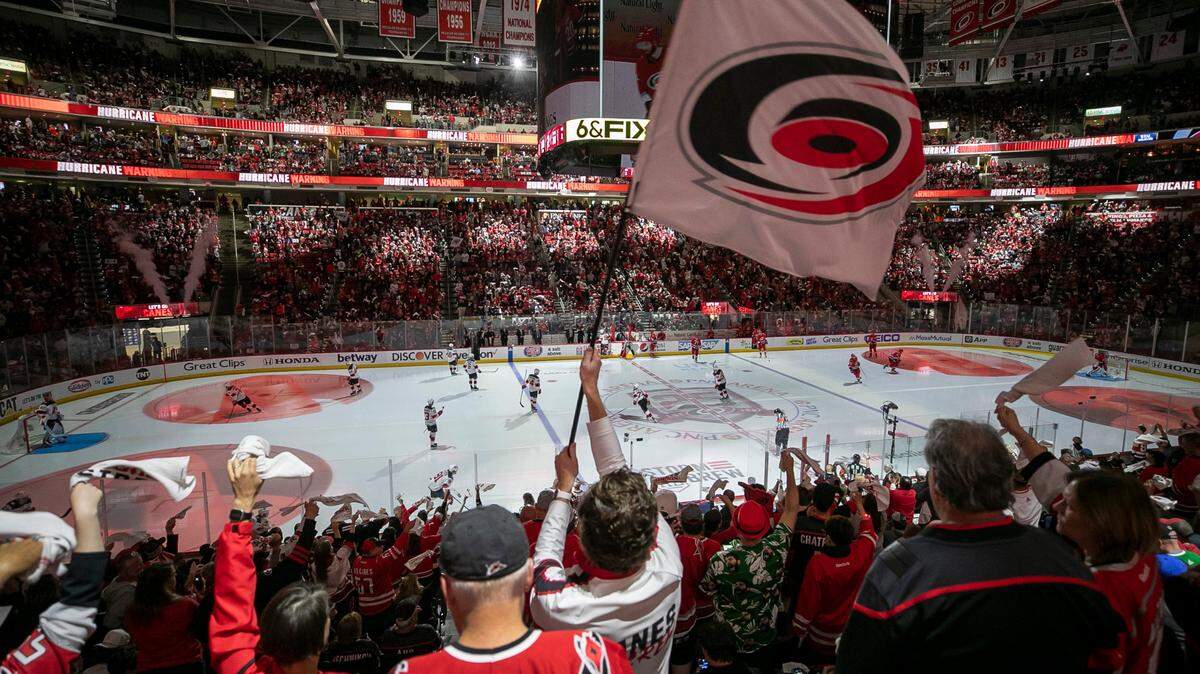 Reis Coeary, a Carolina Hurricanes flag bearer, motivates the crowd at the start of the third period against the New Jersey Devils in Game 5 of their second round Stanley Cup playoff series on Thursday, May 11 at PNC Arena in Raleigh, N.C.