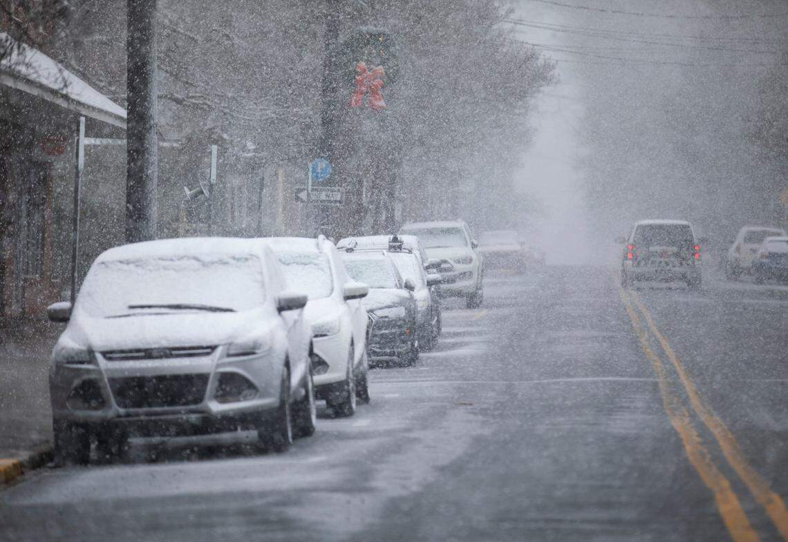 Snow accumulates on cars in downtown Hillsborough, N.C. on Monday, Jan. 3, 2022.