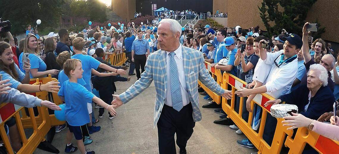 UNC head coach Roy Williams slaps hands with fans at the Smith Center on the campus of UNC-Chapel Hill in Chapel Hill, N.C. Wednesday, March 30, 2016. The men’s basketball team was leaving for their appearance in Houston, Texas at the NCAA National Championship game.