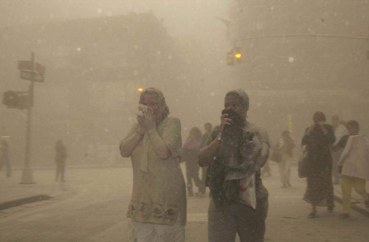 People run from the collapse of World Trade Center Tower Tuesday, Sept. 11, 2001 in New York.