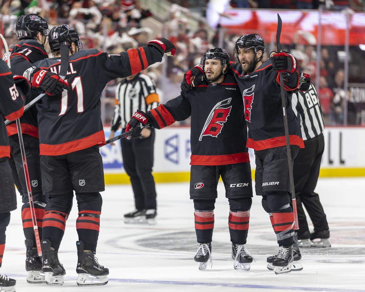 Carolina Hurricanes center Logan Stankoven (22) and Shayne Gostisbehere (4) celebrate with teammates after Stankoven’s goal to take a 2-0 lead in the first period against Montreal during Game 5 of the Eastern Conference Finals on Friday, May 29, 2026 at Lenovo Center in Raleigh, N.C.