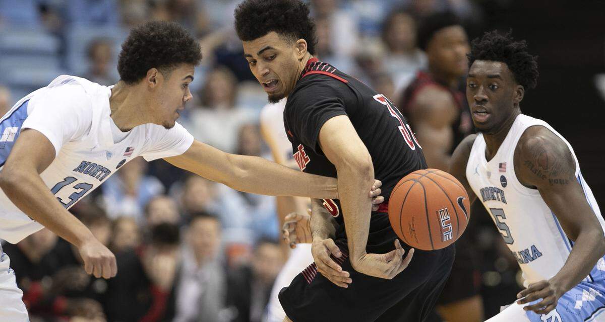 North Carolina’s Cameron Johnson (13) forces a turnover by Louisville’s Dwayne Sutton (24) during the second half on Saturday, January 12, 2019 at the Smith Center in Chapel Hill, N.C.