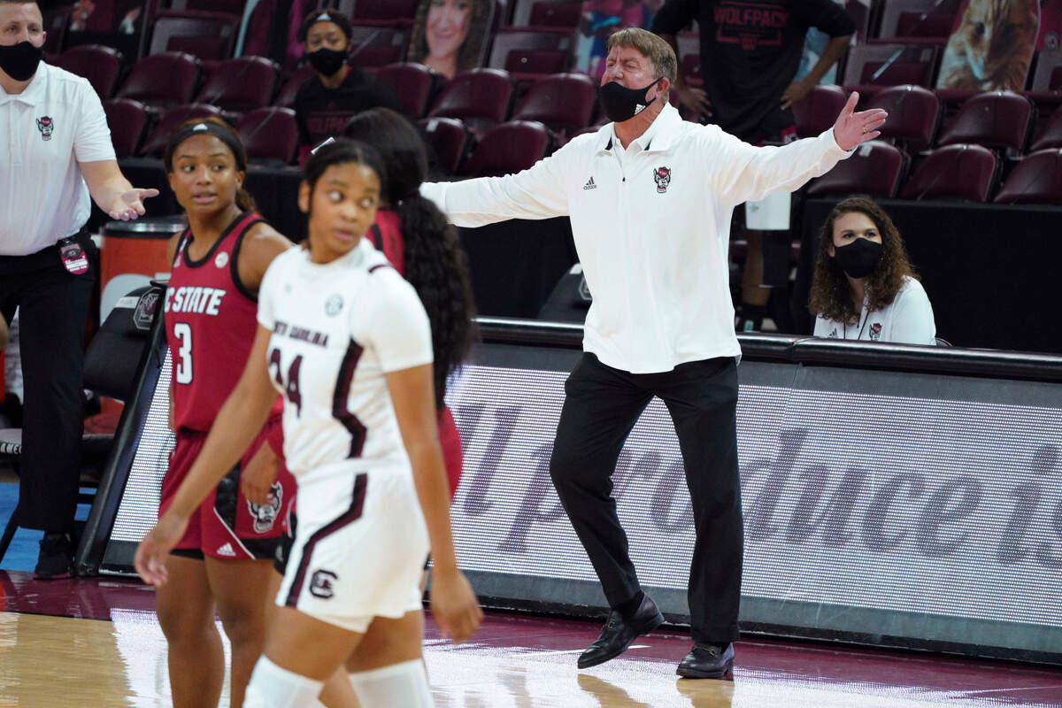 North Carolina State coach Wes Moore talks to an official during the first half of the team’s NCAA college basketball game against South Carolina on Thursday, Dec. 3, 2020, in Columbia, S.C.