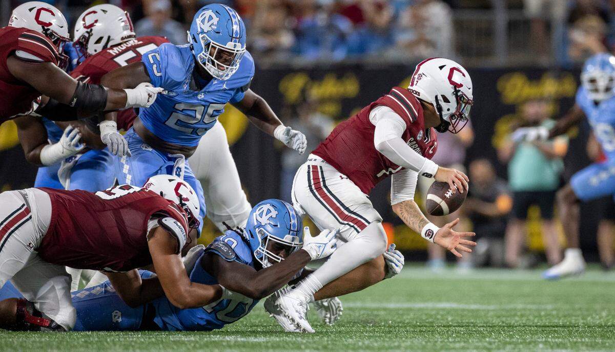 North Carolina’s Desmond Evans (10) sacks South Carolina quarterback Spencer Rattler (7) for a nine-yard loss in the third quarter on Saturday September 2, 2023 at Bank of America Stadium in Charlotte, N.C.
