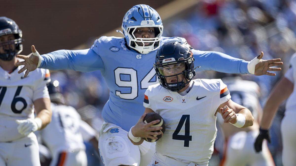 North Carolina defensive lineman Isiah Johnson (94) sacks Virginia quarterback Chandler Morris (4) for a 15 yard loss in the second quarter on Saturday, October 25, 2025 at Kenan Stadium in Chapel Hill, N.C. 