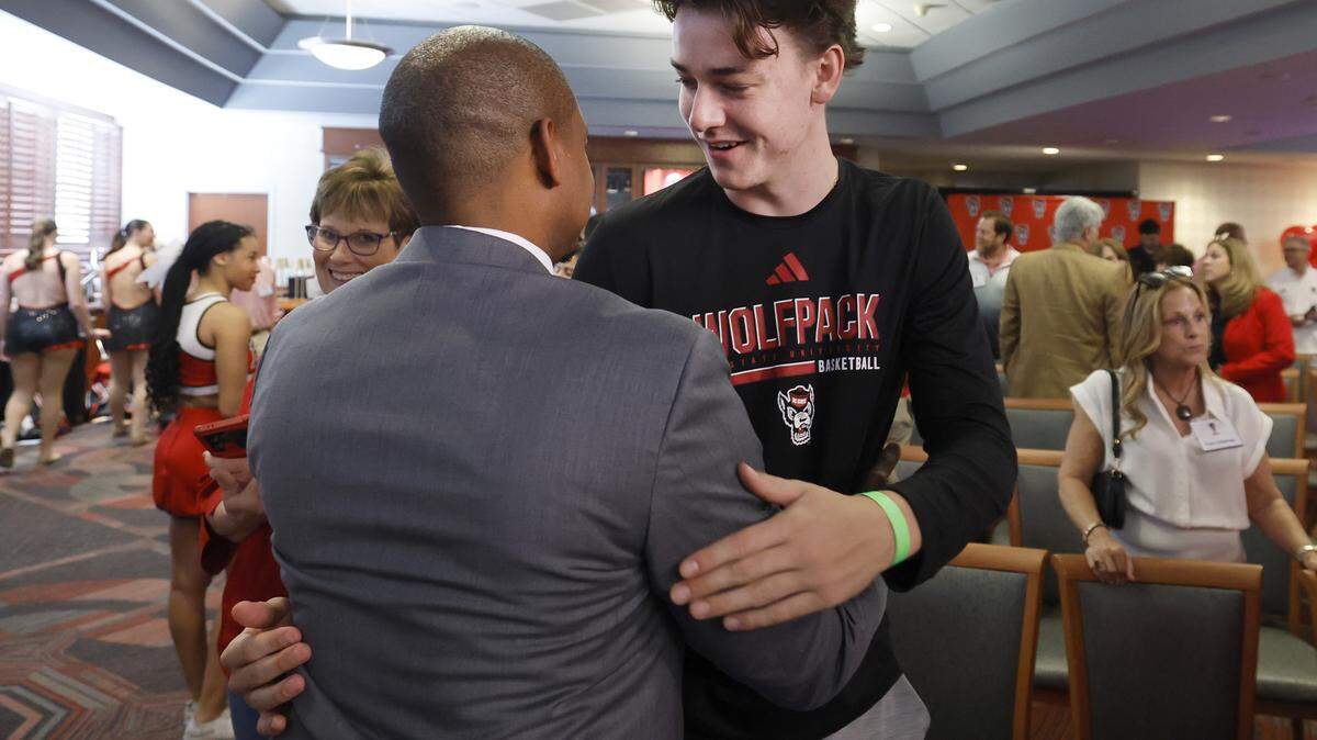 New N.C. State head men’s basketball coach Justin Gainey talks with Cole Cloer after a press conference where Gainey was officially introduced as coach Wednesday, April 1, 2026. Cloer, a class of 2026 prospect, signed with the Wolfpack under Will Wade.