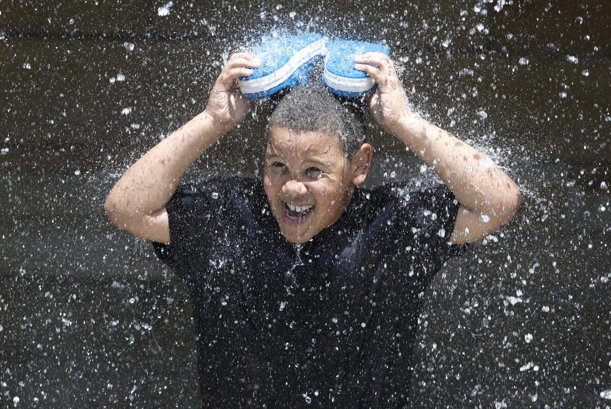 Dylan Warren, 8, of Knightdale enjoys the waterfall at Gipson Play Plaza at Dix Park during a preview day Saturday, May 24, 2025. The park will officially open with a grand opening celebration June 6-8.