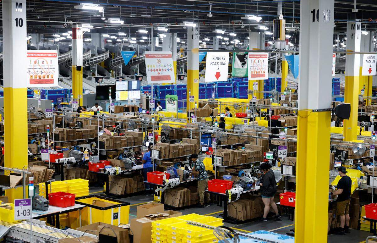 Employees work at RDU1, an Amazon Robotics Fulfillment Center in Garner, N.C., Tuesday, July 1, 2025.