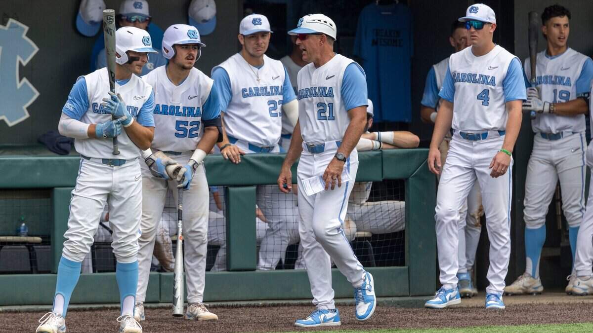 North Carolina coach Scott Forbes (21) talks with batters Mikey Madej (2) and Tomas Frick (52) in the bottom of the ninth inning against Arkansas, during the first game of their Super Regional series on Saturday, June 11, 2022 at Boshamer Stadium in Chapel Hill, N.C. Arkansas defeated North Carolina 4-1.
