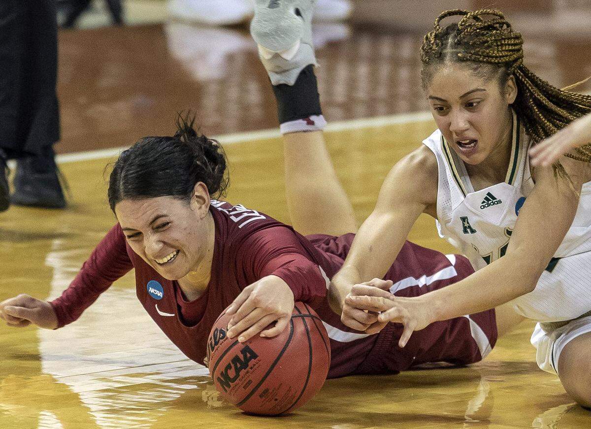 Washington State guard Krystal Leger-Walker, left, dives on the loose ball and calls a timeout against South Florida guard Elena Tsineke (5) during the second half of a college basketball game in the first round of the women’s NCAA tournament, Sunday, March 21, 2021, in Austin, Texas. 