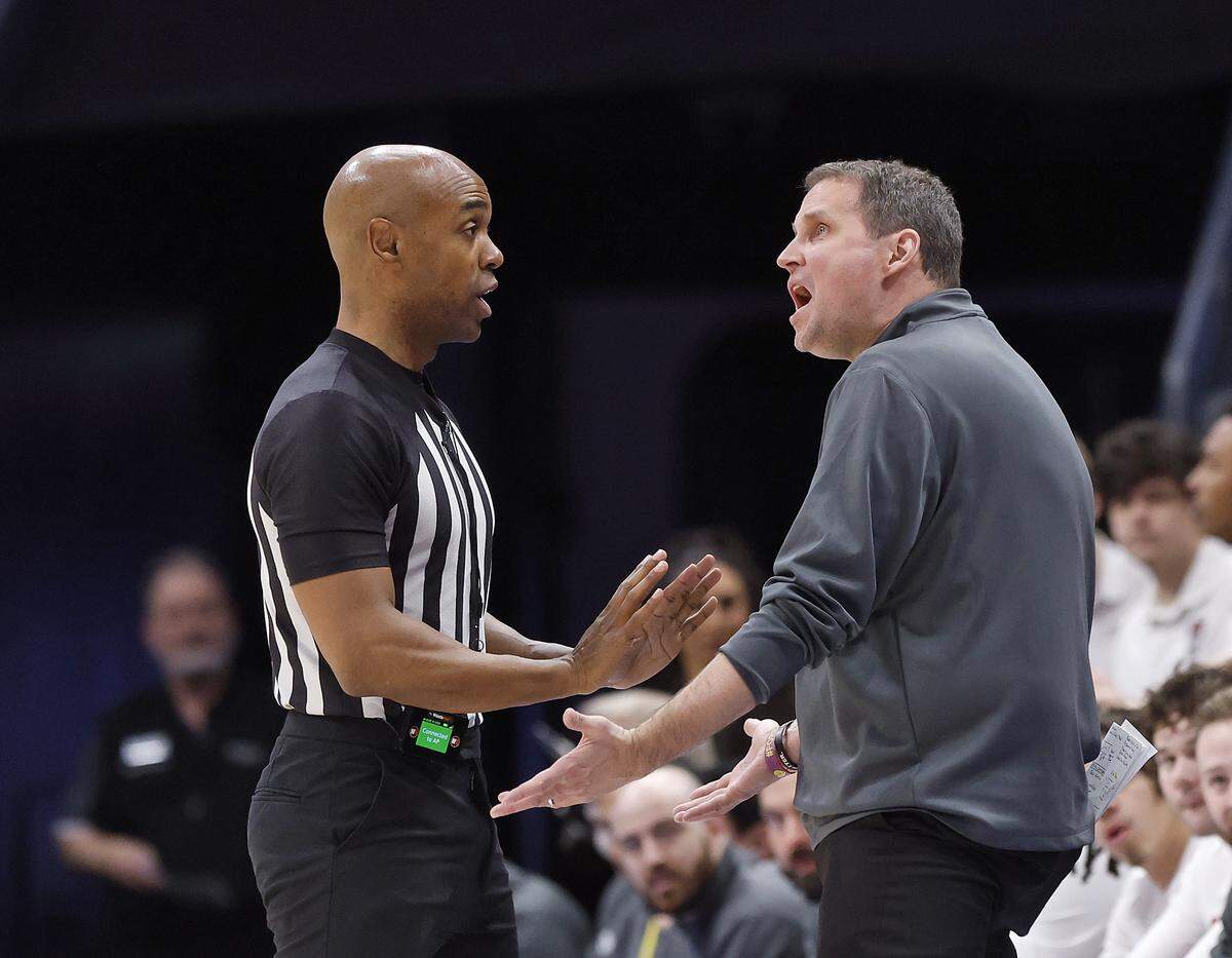 N.C. State head coach Will Wade speaks with an official during the Wolfpack’s ACC tournament game against Virginia on Thursday.