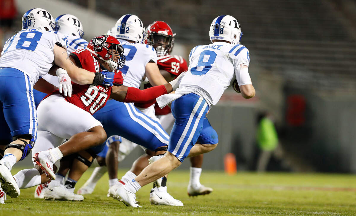 N.C. State defensive end Savion Jackson (90) pressures Duke quarterback Chase Brice (8) during the second half of N.C. State’s 31-20 victory over Duke at Carter-Finley Stadium in Raleigh, N.C., Saturday, Oct. 17, 2020.