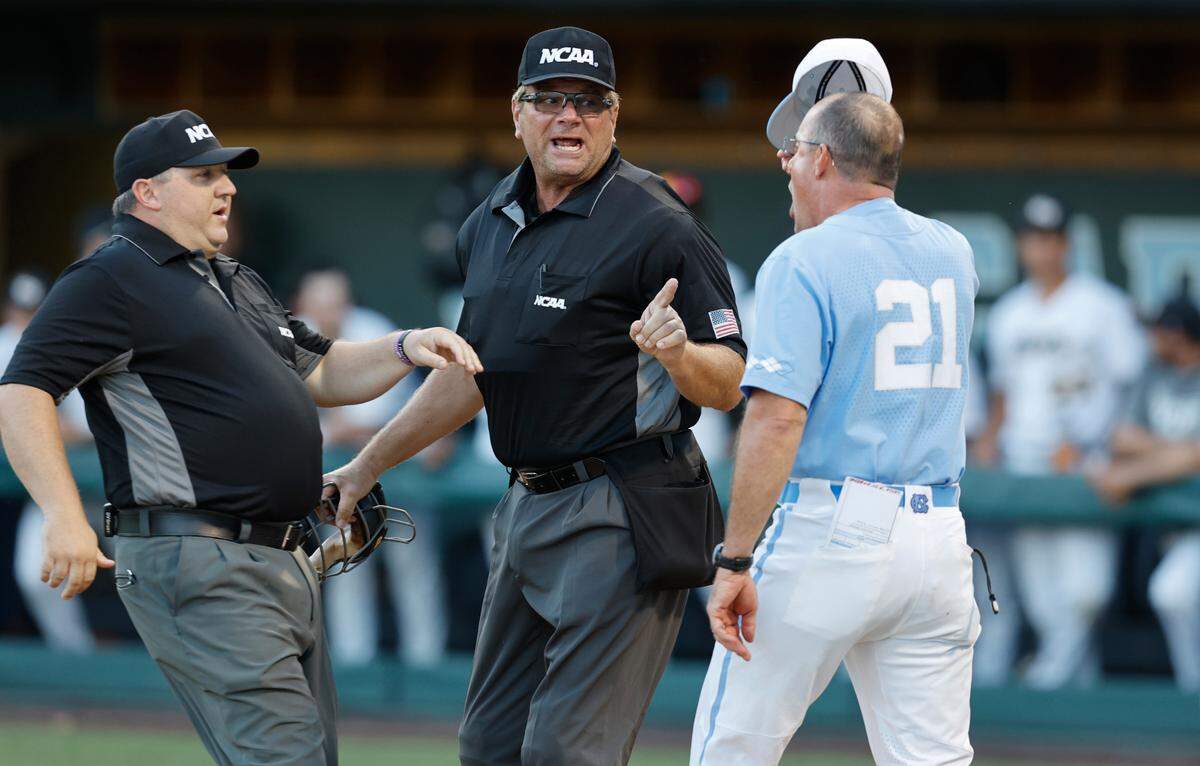 North Carolina head coach Scott Forbes argues with home plate umpire Jeff Henrichs as John Brammer comes in to get between them after Forbes was ejected in the third inning during UNC’s game against VCU in the Chapel Hill Regional at at Boshamer Stadium in Chapel Hill, N.C. Saturday, June 4, 2022.
