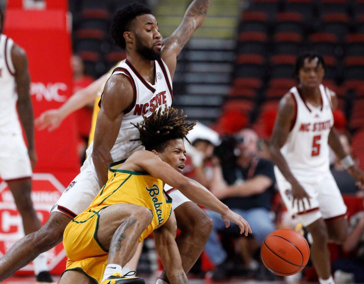 N.C. State’s Dontrez Styles and Lees-McRae’s Dre Jackson collide during the second half of the Wolfpack’s 79-75 exhibition win on Wednesday, Oct. 30, 2024, at the Lenovo Center.