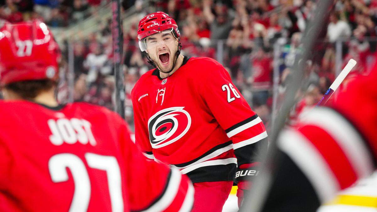 Apr 2, 2025; Raleigh, North Carolina, USA; Carolina Hurricanes defenseman Sean Walker (26) celebrates a goal against the Washington Capitals during the first period at Lenovo Center. Mandatory Credit: James Guillory-Imagn Images