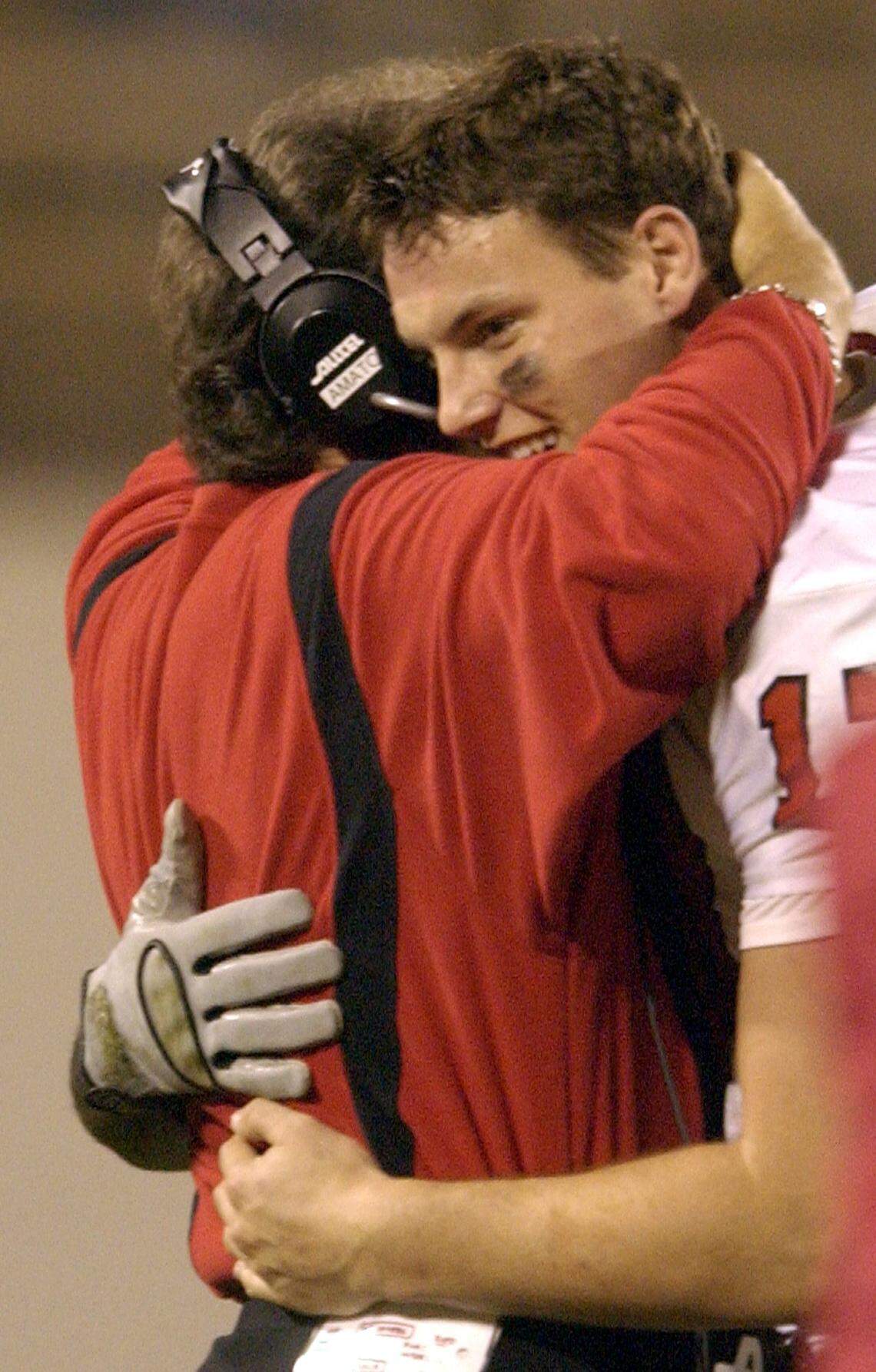 N.C. State quarterback Philip Rivers gets a hug from head coach Chuck Amato as he plays his final play as State beats KU 56-26 in the Tangerine Bowl.