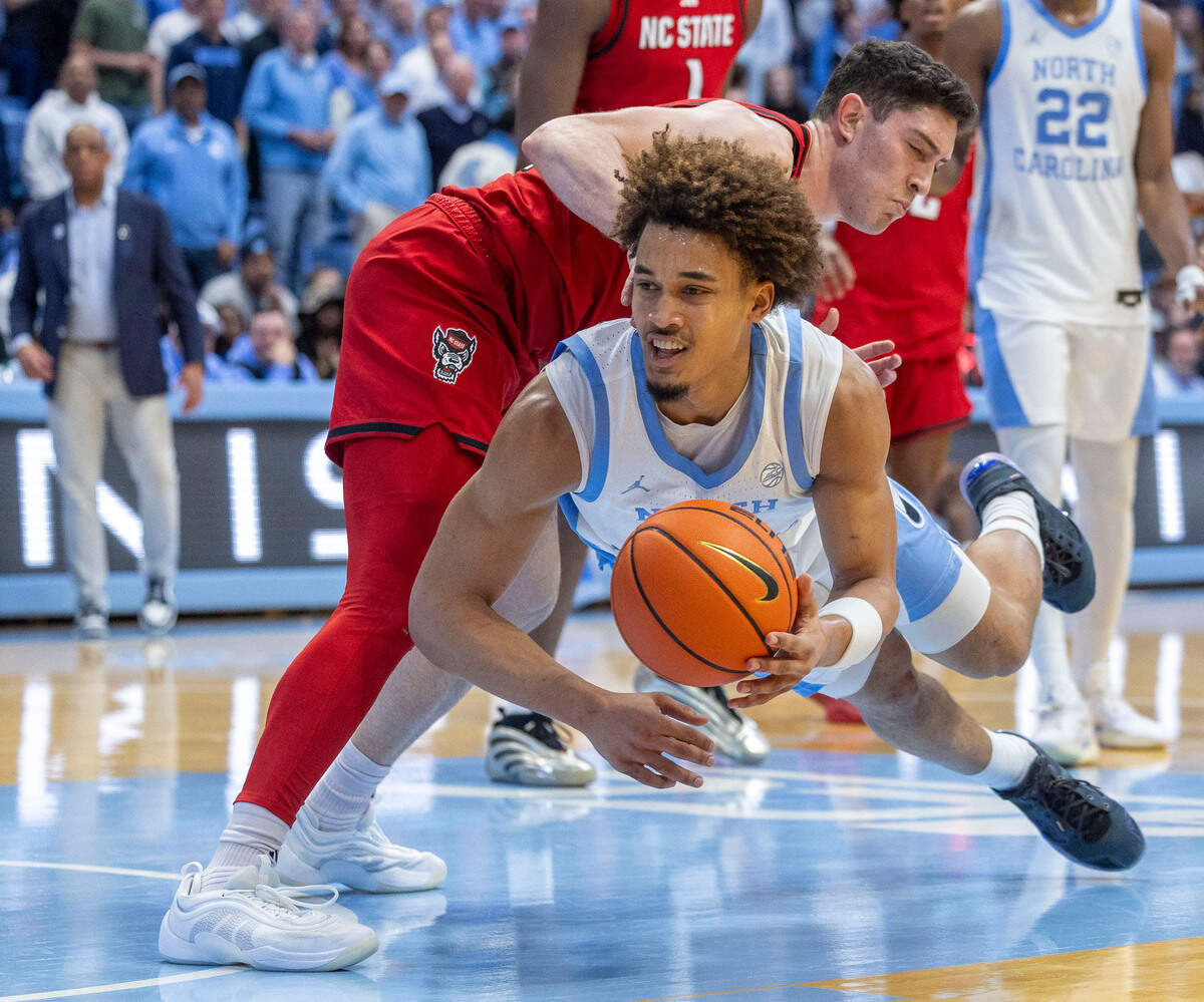 North Carolina guard Seth Trimble (7) dives after the ball under N.C. State’s Michael O’Connell (12) in the second half on Wednesday, February 19, 2025 in Chapel Hill, N.C.