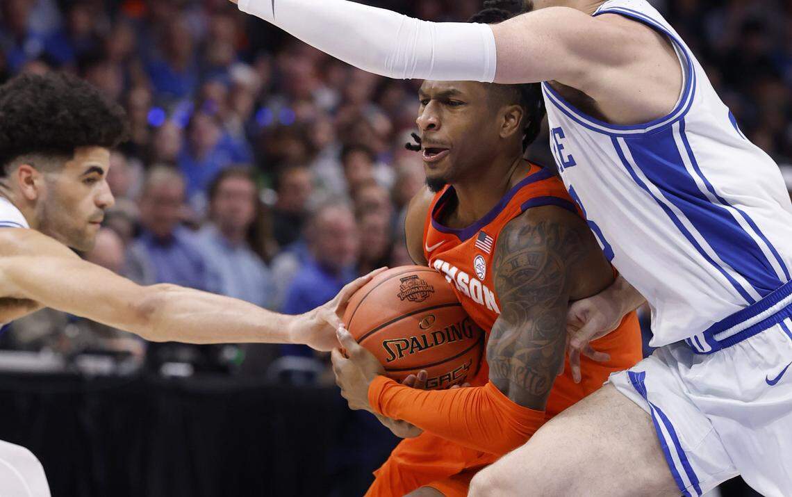 Clemson's Jestin Porter (1) drives by DukeÕs Darren Harris (8) and Cayden Boozer (2) during the first half of DukeÕs game against Clemson in the semifinals of the 2026 ACC MenÕs Basketball Tournament at the Spectrum Center in Charlotte, N.C., Friday, March 13, 2026.