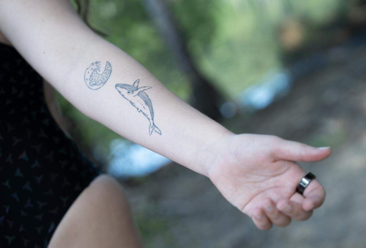 Lorelei Schmidt got these tattoos after an open water swim in Hawaii, where she swam with whales.