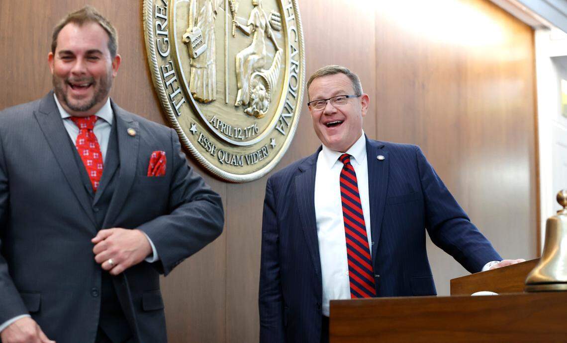 Speaker of the House Tim Moore laughs with Rep. John Bell IV after the opening session of the N.C. House of Representatives Wednesday, Jan. 11, 2023.